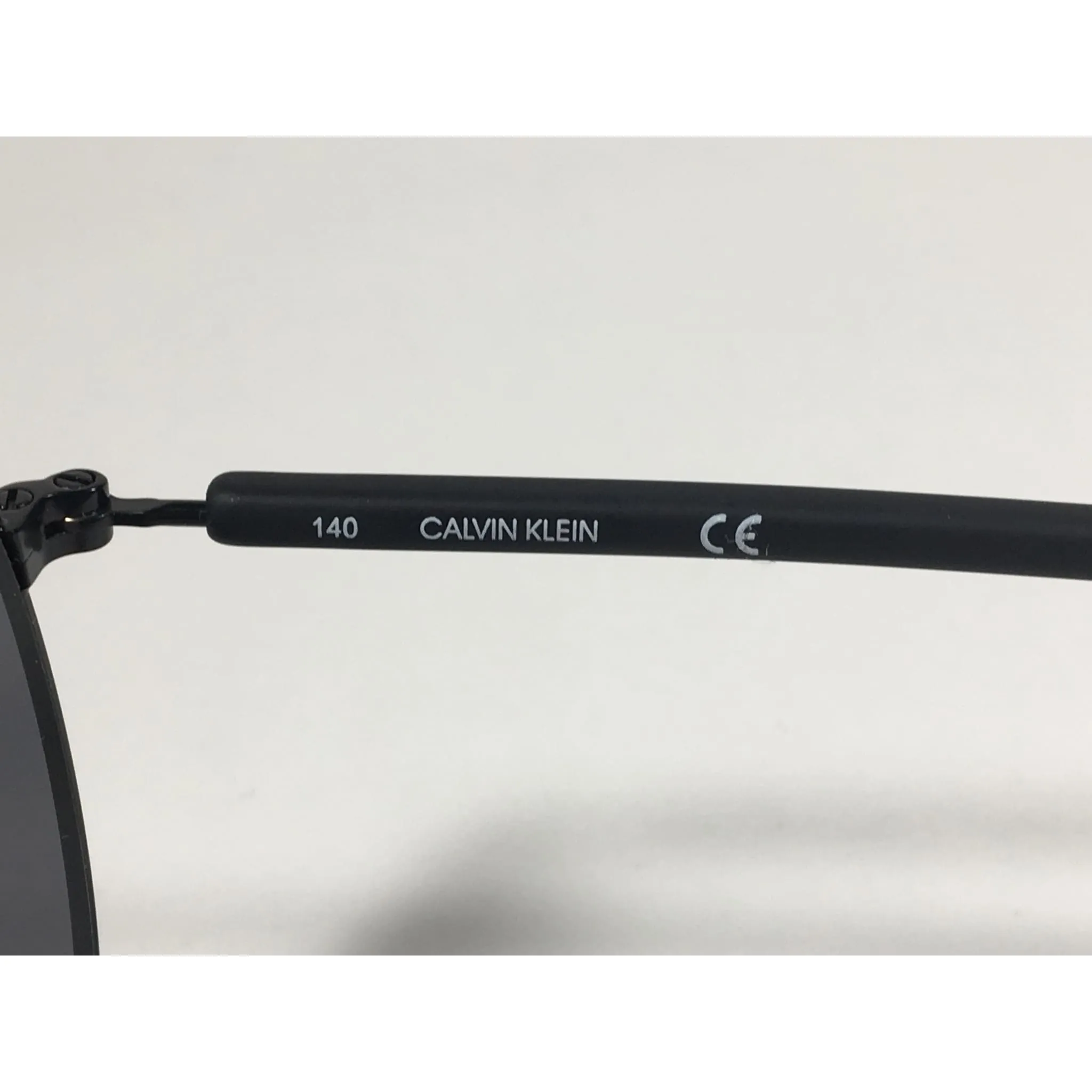 Calvin Klein CK19314S 001 Aviator Pilot Sunglasses Matte Black Metal and Plastic Frame Gray Lens